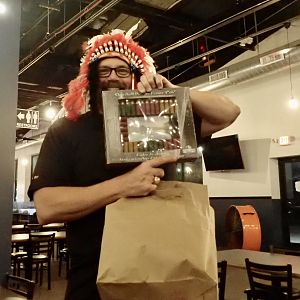 Sioux-shi Boy takes a shot at opening a gift.