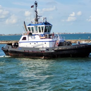 Closeup of blue tugboat Poseidon near Freeport jetties