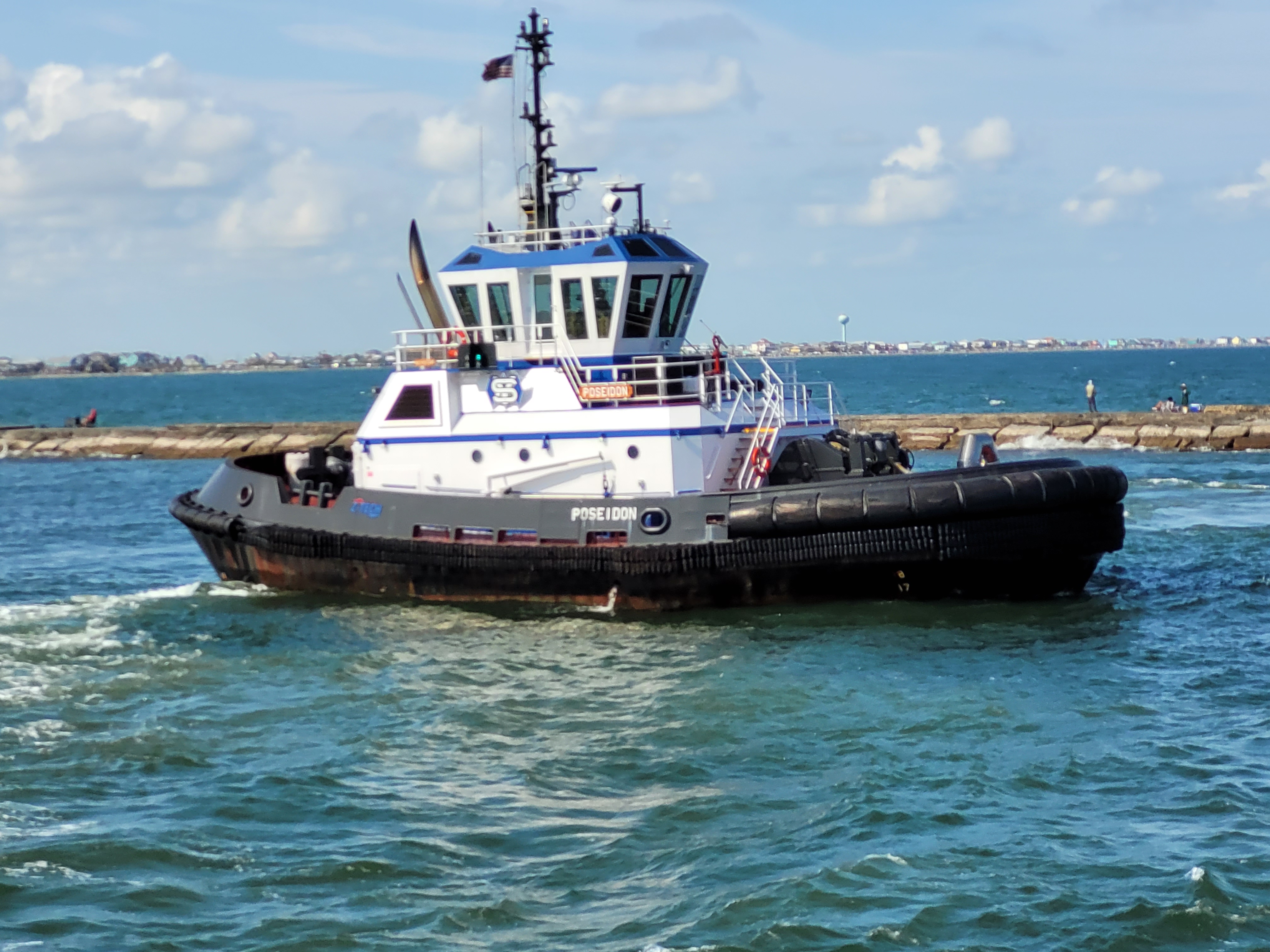 Closeup of blue tugboat Poseidon near Freeport jetties